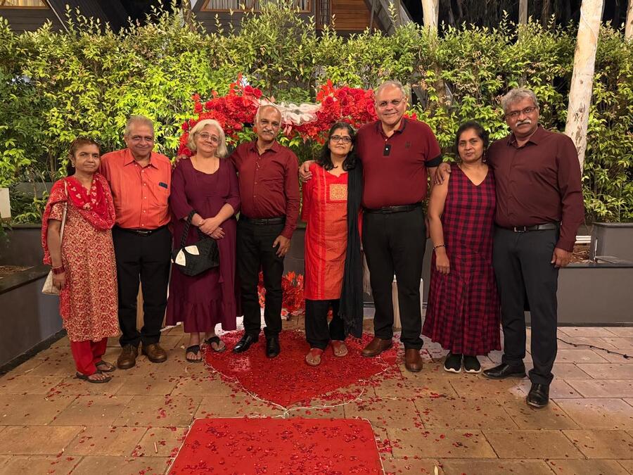 The group dressed in matching red at a celebration