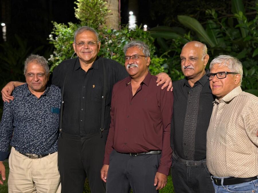 Five friends together in a garden